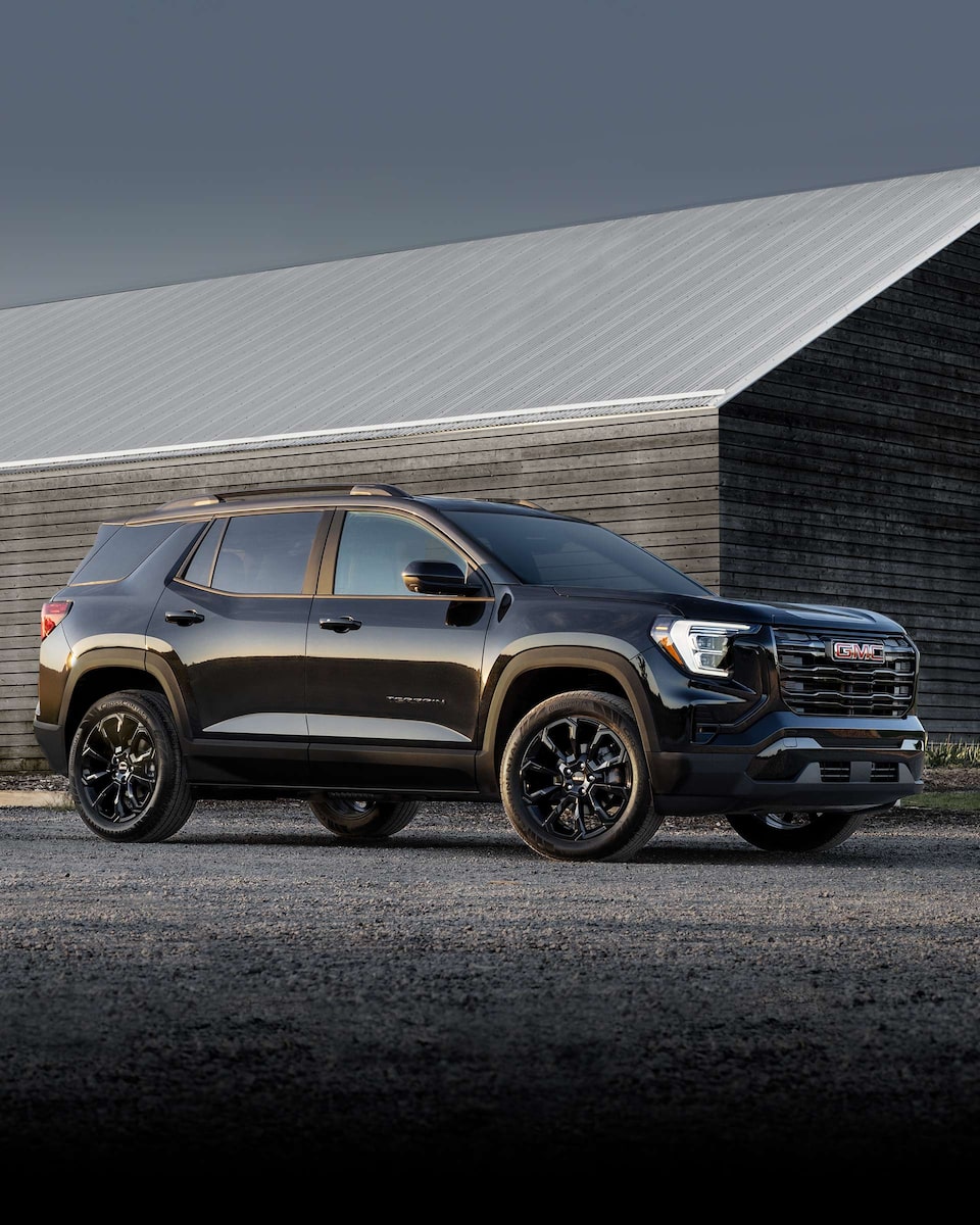 Front Three-Quarters View of a 2024 GMC Terrain Small SUV Driving on an Open Road