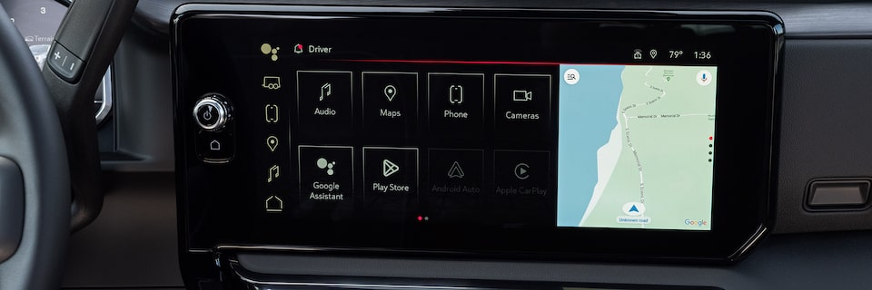 Man in the driver's seat of GMC vehicle pressing the OnStar button