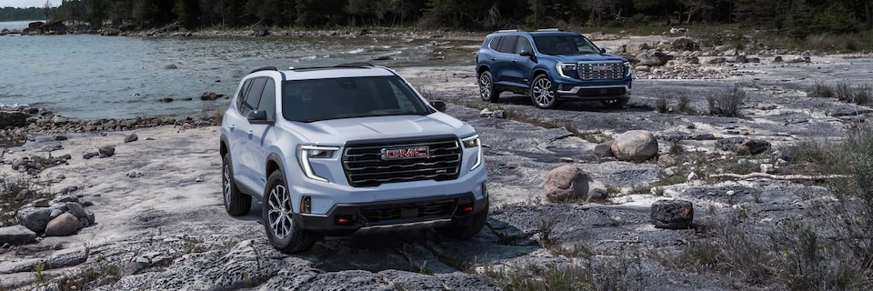 A Blue and White GMC Acadia Parked on the Beach