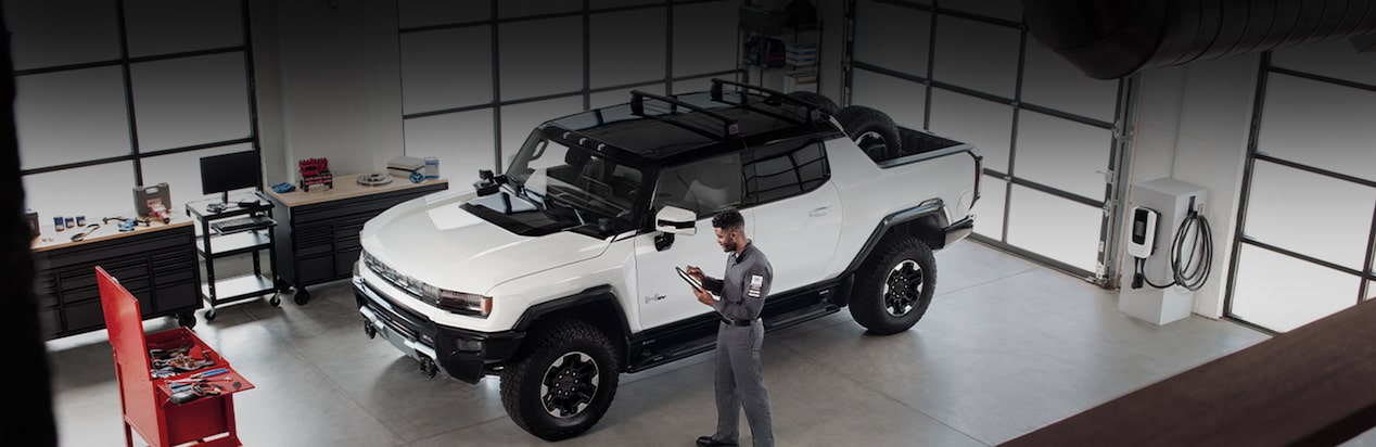 GMC EV Parked in Service Bay with Technician