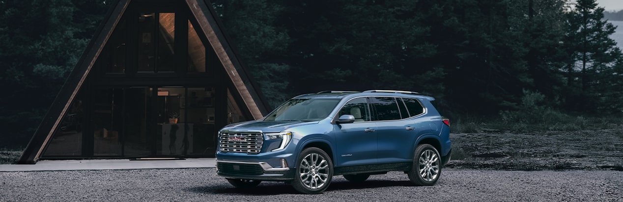  A Blue GMC SUV Parked In Front of A-Frame Home