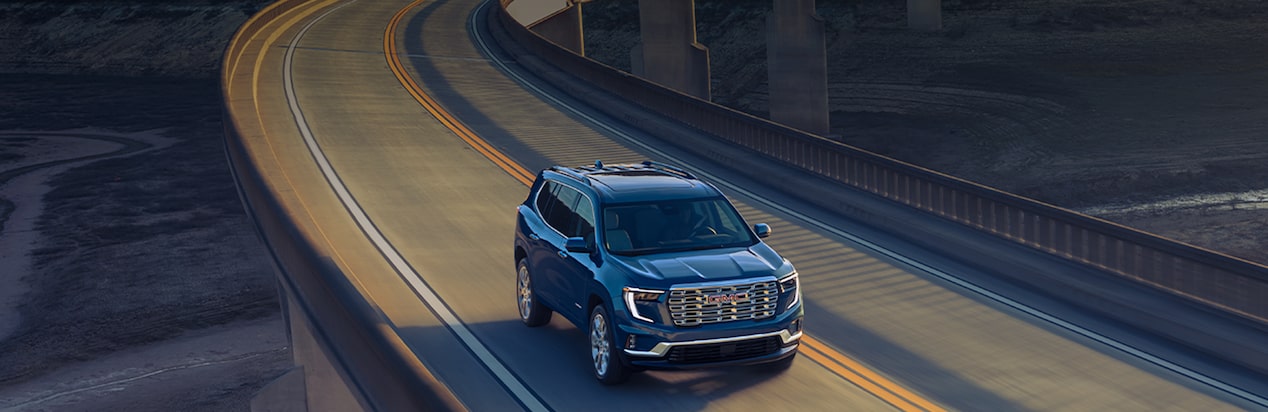 A GMC SUV Drives Across an Elevated Highway