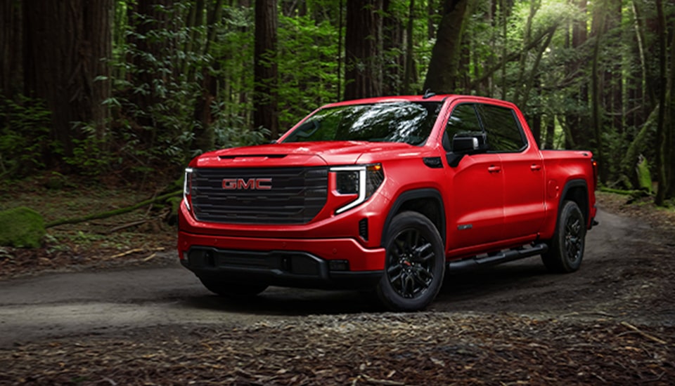 A Red GMC Truck Driving Down a Trail