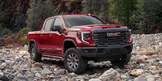 Front Three-Quarters View of the GMC Sierra AT4X 1500 Pickup Truck Parked on Rocky Terrain