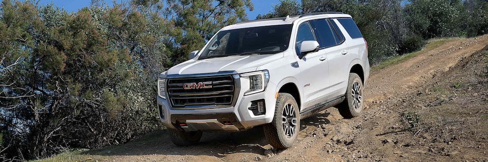 A GMC Yukon AT4 SUV Driving Downhill