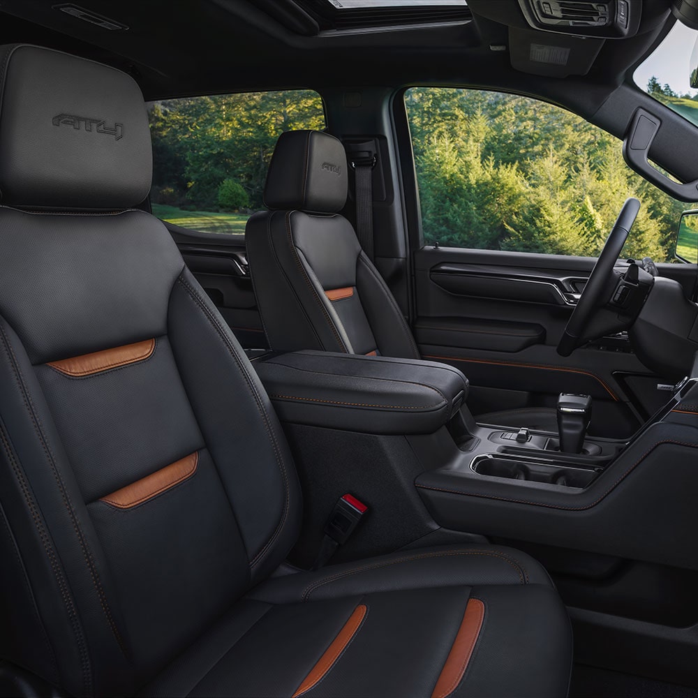 The View From the Passenger Side Door of the Interior Front Row Black Seating in the GMC Sierra Truck