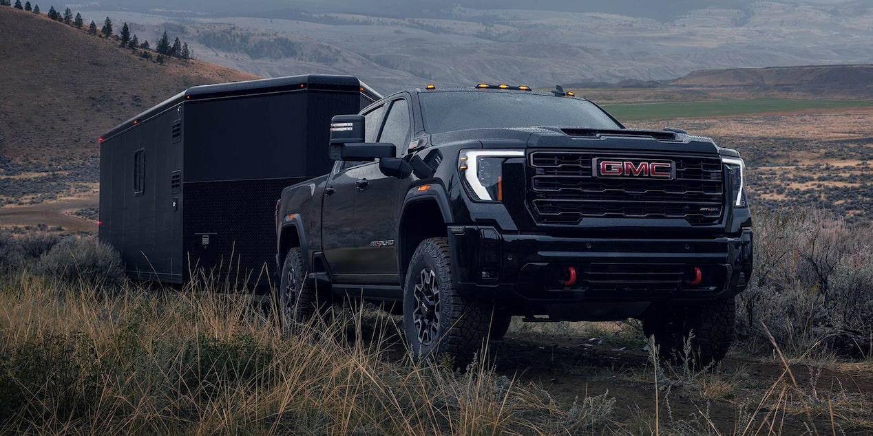 GMC Sierra HD Truck Driving Off-Road While Pulling a Trailer