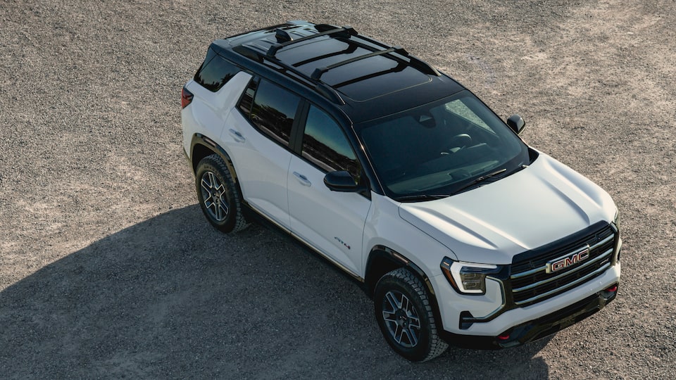 Birdseye Front Three-Quarters View of a 2025 GMC Terrain AT4 Small Off-Road SUV Parked on a Gravel Path