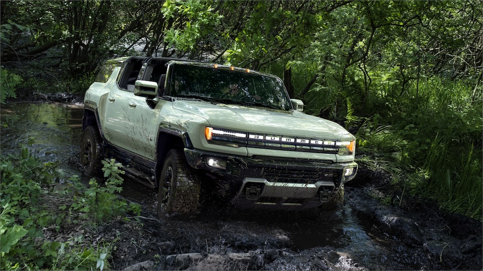 Front Three-Quarter View of the GMC HUMMER EV Driving Off-Road