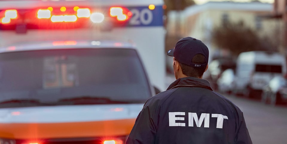 An EMT Standing in Front of an Ambulance