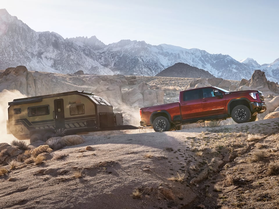 A GMC Truck Hauling a Trailer Through the Desert