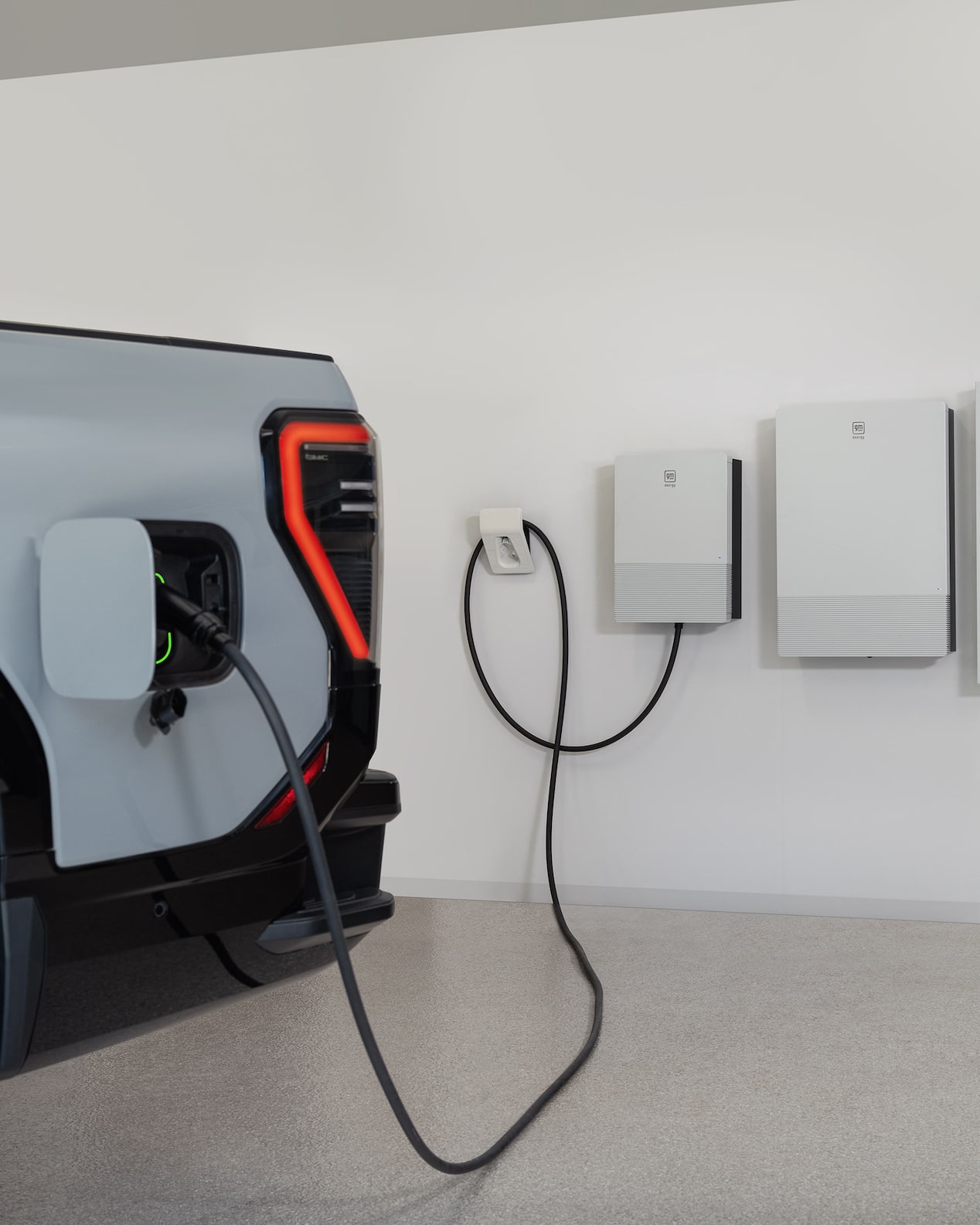 Close-up of a GMC Electric Vehicle Plugged into a Home Charging Station