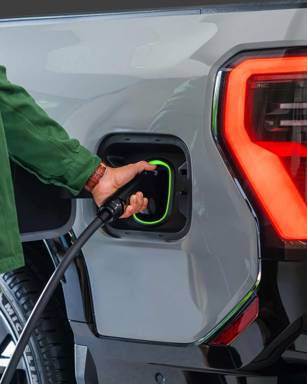 Close-up of a Man Charging His GMC Electric Vehicle