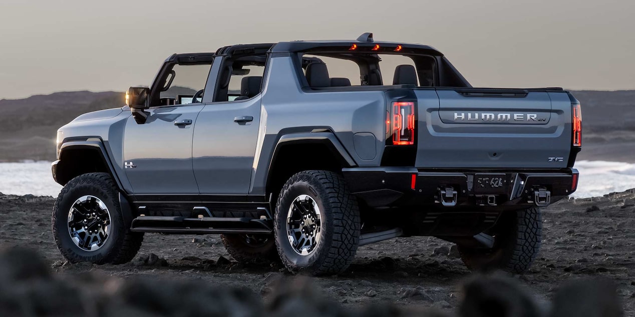 Rear Three-Quarter View of the GMC HUMMER EV Pickup Truck Parked on Rough Terrain