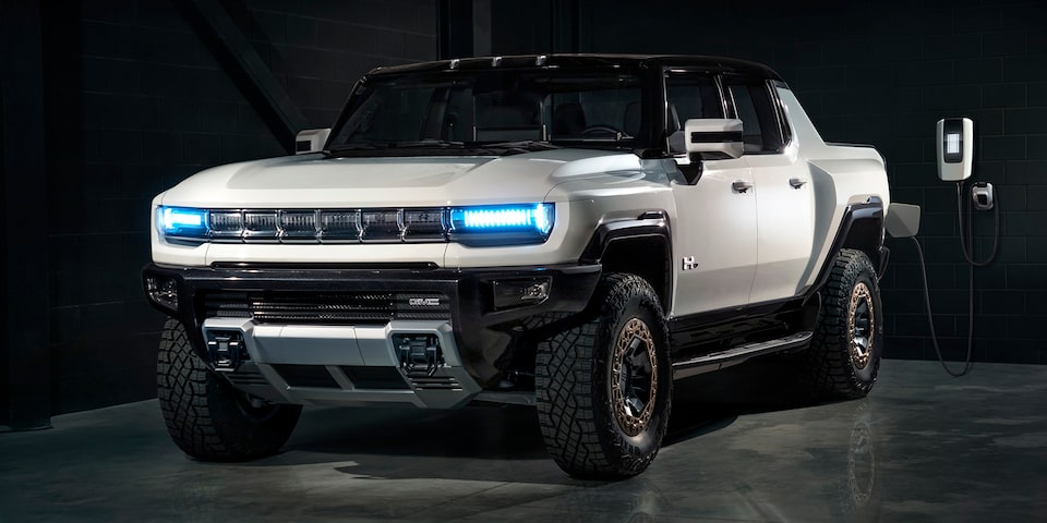 Front Three-Quarter View of a GMC HUMMER EV Pickup Truck Charging at Home