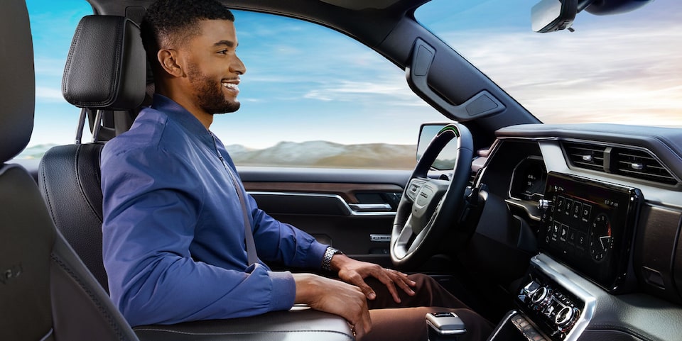 A Smiling Man Sitting in the Driver's Seat