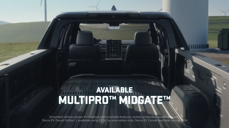 View of the Truck Bed on the GMC Sierra EV Truck with Text Overlay "Available Multipro Midgate"